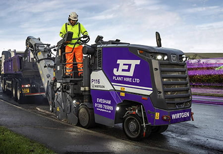 man standing on the JET planer by the side of road
